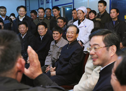 Premier Wen Jiabao (second right) shares a light moment with a group of migrant laborers at a construction site in Xiangtan, Hunan Province, during a trip to the central province on New Year's Day in 