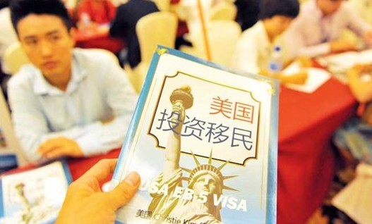 A brochure for immigration to the US is distributed at a study-abroad fair held in Xiamen, Fujian Province, on November 6, 2011.Photo: CFP