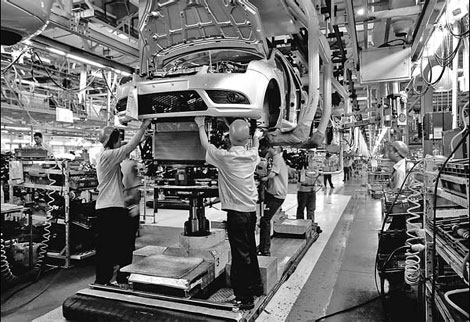 Workers assemble Ford cars on the assembly line at Changan Ford, the joint venture between Chang'an Automobile (Group) Co Ltd and Ford Motor Co in Chongqing. Provided to China Daily