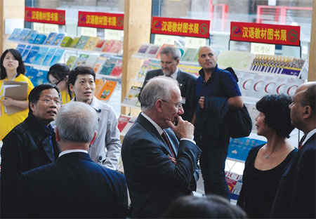 Visitors take a look around an exhibition of Chinese-language books in London sponsored by China's Hanban before attending the second conference on Confucius institutes in Europe last September. [Photo/Xinhua]