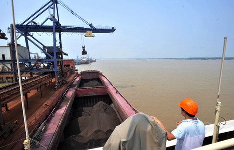 Iron concentrate from Brazil arrives at the port of Ningbo city, Zhejiang province. Officials say that as the effects of China's macroeconomic regulations and control measures continue to be felt, it's possible that iron ore prices could fall further.