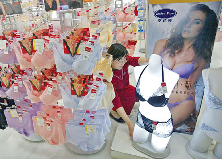 A saleswoman dressing a lingerie model at a department store in Nanjing, the capital city of Jiangsu province. Chinese women are no longer satisfied with merely comfortable bras, knickers or nightwear. They want attractive styles and a sense of luxury in 
