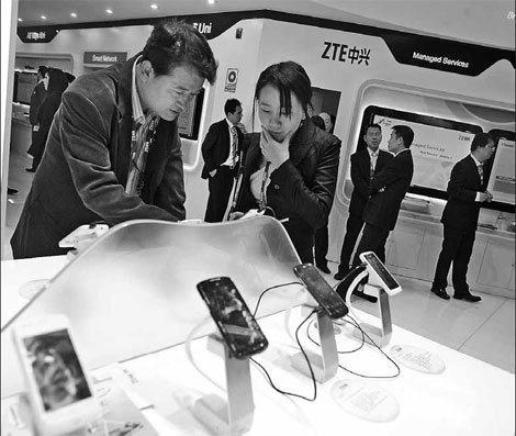 Visitors inspect ZTE Corp smartphones on display at the company's booth at the Mobile World Congress in Barcelona, Spain, on Feb 28. The company has become the first Chinese supplier to launch a Windows Phone handset in China. 
