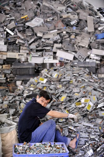 A worker at an e-waste disposal workshop in Shantou, Guangdong province, has a rest on May 31. 