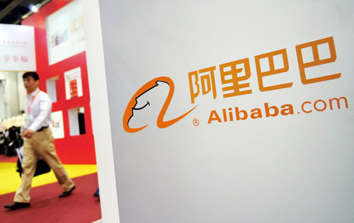 A man walks by the booth of Alibaba Group Holdings Ltd at the 2012 International E-shopping Fair in Shanghai, June 7, 2012. [Jingwei/Asianewsphoto] 