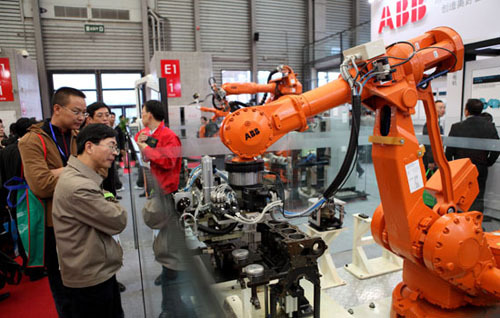 Robots made by ABB Ltd are shown at an exhibition in Shanghai in 2009. The Swiss engineering group said it will set up more than 20 service hubs and centers across China, as part of its $500 million investment plans over the next five years in the country, despite rising costs and cooling economic growth. [Photo/China Daily]