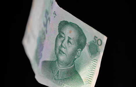 A Chinese 50 yuan banknote is seen in this photo illustration taken in Beijing, Oct 12, 2012. [Photo/chinadaily.com.cn] 