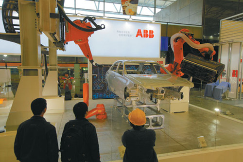 An industrial robot from ABB Group is displayed at the China International Industrial Fair in Shanghai on Monday. The group said China will soon become the largest industrial robotics market in the world. Gao Erqiang / China Daily