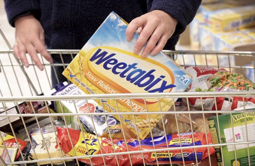 A shopper places a box of Weetabix into a shopping cart. China's Bright Food Group Co Ltd paid nearly $1.12 billion to acquire a 60 percent stake in the cereal brand. JASON ALDEN / BLOOMBERG