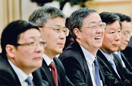 Delegates from the country's top financial organizations discuss Hu Jintao's report at the 18th Party Congress on Thursday. From left, China Investment Corp Chairman Lou Jiwei, China Securities Regulatory Commission Chairman Guo Shuqing, People's Bank of China Governor Zhou Xiaochuan and China Banking Regulatory Commission Chairman Shang Fulin. [Xu Jingxing / China Daily]