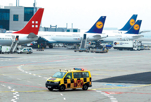 An airport vehicle drives past aircraft at the airport in Frankfurt, Germany. The European Union said on Monday that it will freeze its rules on air-carbon taxes for a year to let an alternative plan to help curb rising airline emissions be agreed on. ALE