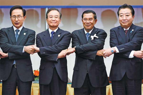 Premier Wen Jiabao, South Korean President Lee Myung-bak (left), Cambodias Prime Minister Hun Sen and Japan's Prime Minister Yoshihiko Noda (right) hold hands for a photo at the ASEAN Plus Three session of the 21st ASEAN and East Asia summits in Phnom Penh, Cambodia, on Monday. [Photo/Agencies] 