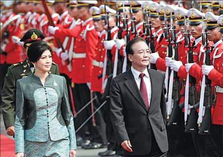 Premier Wen Jiabao, accompanied by Thai Prime Minister Yingluck Shinawatra, reviews an honor guard during a welcome ceremony at the government house in Bangkok, Thailand, on Wednesday. Sakchai Lalit / Associated Press 