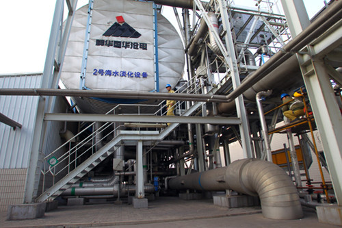 Workers check seawater desalination equipment at Shenhua Group Co in Cangzhou, Hebei province. [Photo by Zou Hong / China Daily]