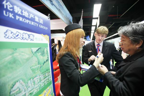 Staff members of a property group in London introduce their houses to Chinese customers at an exhibition in Beijing. [Photo/China Daily]