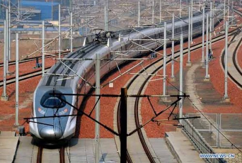 A bullet train from Guangzhou, capital of south China's Guandong Province, enters the Zhengzhou East Railway Station in Zhengzhou, capital of central China's Henan Province, Dec. 25, 2012. According to an announcement of the Ministry of Railways, the Beijing-Guangzhou high-speed railway, which links China's capital and Guangzhou, is expected to cut the travel time to about 8 hours from the current 20-odd hours by traditional lines. (Xinhua/Wang Song)