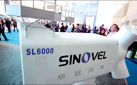 Visitors examine a model of a Sinovel Wind Group turbine. The company is one of China's leading manufacturers of large-scale onshore, offshore and inter-tidal equipment. Wu Changqing / for China Daily