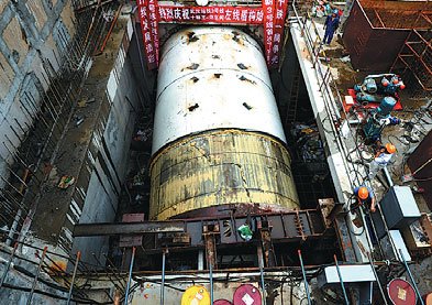 A boring machine begins to tunnel at a construction site for subway Line 3 in Wuhan, capital of Hubei province, on Sept 11. As the city's first subway line linking Hankou and Hanyang, two key areas of the city, the first stage project of the line is expected to open to traffic in 2015. Jin Siliu / for China Daily 