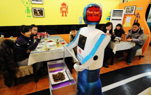 A robot serves dishes in a robot themed restaurant in Harbin, capital of northeast China's Heilongjiang Province, Jan. 18, 2013. Opened in June of 2012, the restaurant has gained fame by using a total of 20 robots to cook meals, deliver dishes and greet customers. (Xinhua/Wang Jianwei) 