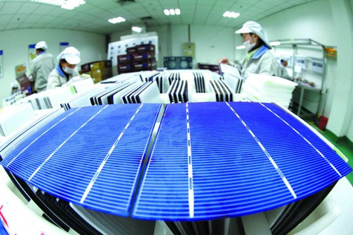 Technicians inspect solar-panel products ready for the European market in Ganyu, Jiangsu province. The European Union may impose anti-dumping tariff s on Chinese solar panels. [SI WEI/FOR CHINA DAILY]