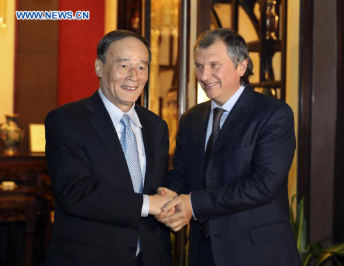 Chinese Vice Premier Wang Qishan (L) shakes hands with Igor Sechin, president of Russia's state-owned oil producer Rosneft and executive secretary of the commission on the strategic development of Russia's energy sector, in Beijing, capital of China, Feb. 17, 2013. (Xinhua/Ding Lin)  