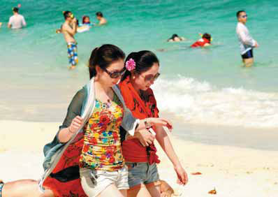 Two Chinese women walking on the beach in Phuket, Thailand. Many Chinese travelers chose to stay closer to home, choosing Asian destinations. Provided to China Daily