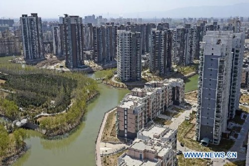 Photo taken on April 10, 2013 shows a commercial apartment community under construction in Yinchuan, northwest China's Ningxia Hui Autonomous Region. New home prices rose in almost all Chinese cities in March, as transactions soared ahead of renewed government control measures, data from the National Bureau of Statistics (NBS) showed on April 18. Of a statistical pool of 70 major Chinese cities, 68 saw home prices increase in March from a month earlier, up from 66 in February, the NBS said in a statement on its website. (Xinhua/Wang Peng)