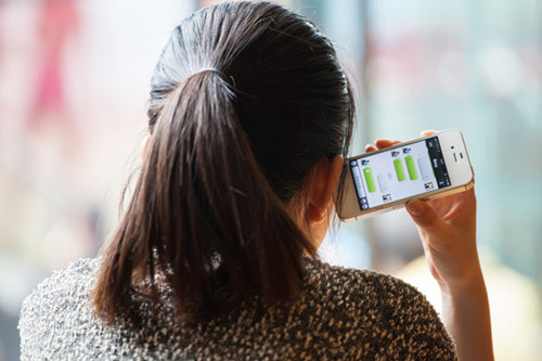 A woman in Shanghai uses WeChat on her smartphone. Provided to China Daily