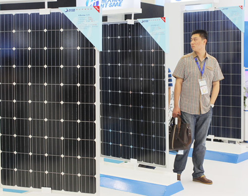 Solar panels on display at a solar and photovoltaic industry show in Shanghai on Tuesday. China has launched anti-dumping and anti-subsidy investigations into solar-grade polysilicon, an ingredient in solar panels, imported from the United States. GAO ERQIANG/CHINA DAILY