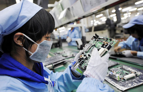 A worker inspects a circuit board at an electronics factory in Dongguan, Guangdong province. Appreciation of the yuan has put huge pressure on smaller-scale businesses in the Pearl River Delta region, forcing some to relocate or shut down altogether. CHEN YEHUA/XINHUA