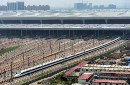 A high-speed train leaves the Hangzhou East Station for Nanjing in Hangzhou, capital of east China's Zhejiang Province, May 24, 2013. High-speed rail lines from Nanjing to Hangzhou and Hangzhou to Ningbo began a month-long trial operations on Friday. (Xinhua/Han Chuanhao)