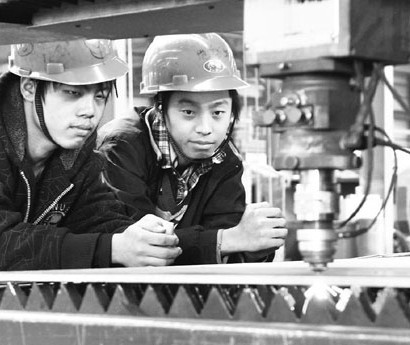 Two technicians examining a production line at Shandong Kaitai Group, an engineering equipment producer based in Shandong province. Kaitai has so far set up overseas branches in Europe, Asia and the Middle East. Last year it successfully acquired Airblast B.V. of the Netherlands. Provided to China Daily