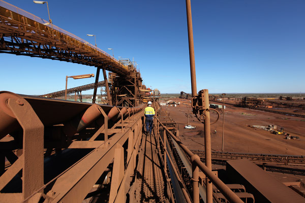 A manager inspects ore processing equipment near a mine of FMG, the worlds fourth largest iron ore miner. Despite an economic slowdown, Chinas advancing urbanization and the growth will continue to create demand for Australian iron ore.DU JUAN/China Daily