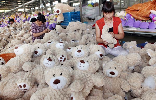 Workers inspect toys at a factory in Lianyungang, Jiangsu province. The manufacturing sector contributes about 40 percent to China's annual GDP, with 60 percent of it coming from SMEs. Si Wei/For China Daily