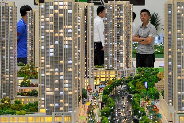 Buyers choose houses at a sales room in Guiyang, capital of Guizhou province. The average price of new homes in the 100 monitored cities reached 10,347 yuan ($1,688) per square meter in July. [Ou Dongqu/Xinhua]