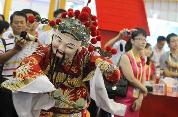 A god of fortune extends his good wishes at a ceremony to mark the start of the 17th China International Fair for Investment and Trade on Sunday in the coastal city of Xiamen, Fujian province. More than 670 delegations from 100 countries and regions are attending the fair. Zhu Xingxin/china daily