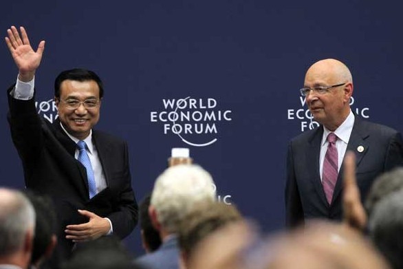 Premier Li Keqiang, accompanied by Klaus Schwab, executive chairman of the World Economic Forum, meets business representatives before the World Economic Forum Annual Meeting of the New Champions, also known as the Summer Davos, in Dalian on Tuesday. The three-day forum is scheduled to start on Wednesday.[ZOU HONG/CHINA DAILY]