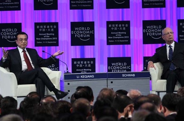 Premier Li Keqiang and Klaus Schwab, founder and executive chairman of the World Economic Forum, attend the opening ceremony of the forum's Annual Meeting of the New Champions 2013 in Dalian, Liaoning province. Li said China's economy has entered a phase of medium-to-high growth, striking an optimistic tone on continuing stable and sustainable development. [Zou Hong/China Daily ]