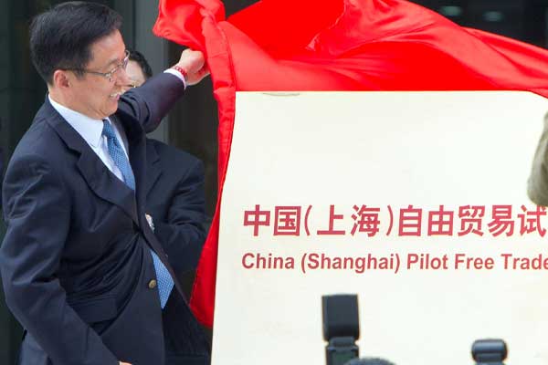 Shanghai's top leader Han Zheng attends the inaugural ceremony of the Shanghai pilot free trade zone on Sunday. Thirty-six companies were given licenses to operate in the zone, which covers more than 28 square kilometers.[Gao Erqiang / China Daily]