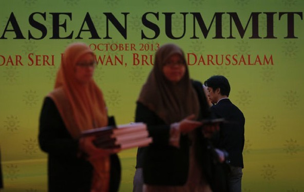 Officials get ready for the Association of Southeast Asian Nations summit in Bandar Seri Begawan, Brunei, on Monday. Leaders of the 10 ASEAN nations, as well as those of China, Japan and South Korea, will be joined by leaders of Russia, the United States and India. Vincent Thian/Associated Press
