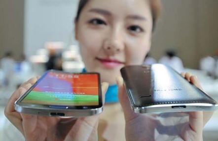A model shows off Samsung's first curved display panel smartphone, the Galaxy Round, at the Electronics and IT Industry Fair in Goyang, north of Seoul, on Thursday. Jung Yeon-Je / Agence France-Presse