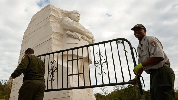 National Park workers remove a barricade at the Martin Luther King Jr. Memorial as it reopens to the public in Washington on Thursday. A last-minute deal on the debt ceiling by the US Congress ended the government shutdown. Kevin Lamarque / Reuters