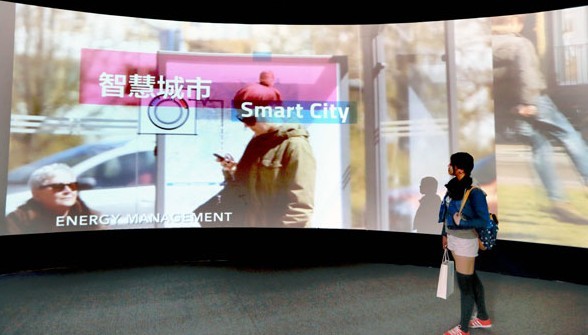 A visitor to the Smart City 2013 exhibition in Beijing in September looks at a display. Provided to China Daily