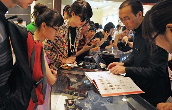Checking a catalogue of Omega watches at a duty free store in Sanya city in 2011. Zhu Lan / For China Daily  