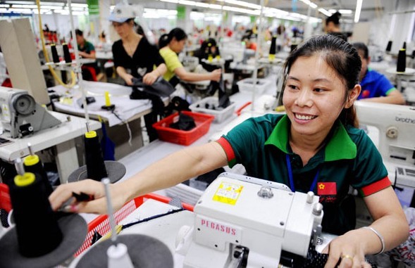 Workers made clothes at a private company in Dexing, Jiangxi province. In 2012, the proportion of private enterprise in China's GDP exceeded 60 percent.[Photo / China Daily]