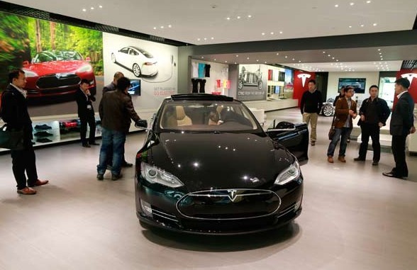 Visitors at Tesla Motors' Beijing store. The Palo Alto, Calif.-based company expects sales to reach 20,000 cars in 2013 and to double to 40,000 in 2014. Feng Yongbin / China Daily  