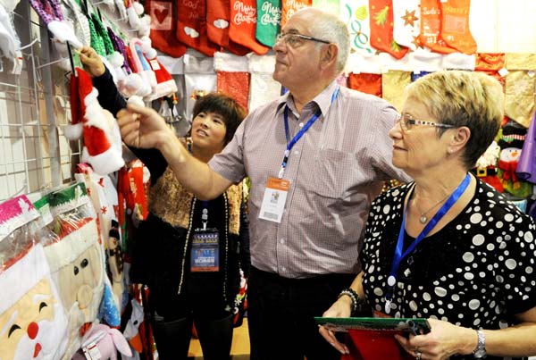 Two buyers examine products for Christmas in Yiwu, Zhejiang province. Thanks to stronger demands from the United States and European Union, China's exports in October increased 5.6 percent year-on-year, the General Administration of Customs said on Friday. Zhang Jiancheng / For China Daily