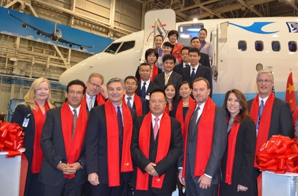 Executives from Boeing and Xiamen Airlines celebrate the delivery of Xiamen Airlines' 100th airplane. Front row from left to right: Ihssane Mounir, senior vice president for Sales for Northeast Asia of Boeing Commercial Airplanes, Raymond Conner, executive vice president of the Boeing Company and president & CEO of Boeing Commercial Airlines, Che Shanglun, president and chairman of Xiamen Airlines. Deng Yu / China Daily USA  