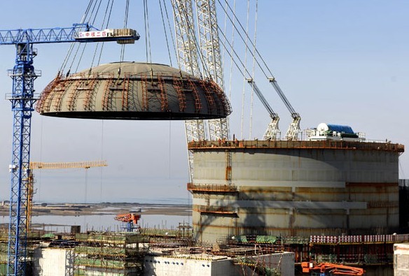 A steel dome is hoisted onto the No 1 reactor at Haiyang nuclear power plant in Shandong province in March. China plans to have an installed nuclear power capacity of 58 gigawatts by 2020. LI ZIHENG / XINHUA  