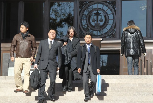 Lawyers representing Qihoo 360 Technology Co leave the Supreme People's Court on Tuesday at noon after court adjourned. The court opened the trial against Tencent Inc, which is accused by Qihoo of abusing its dominant position in the market. ZHU XINGXIN / CHINA DAILY  
